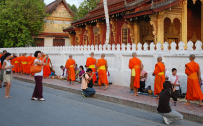 Morning alms in Luang Prabang: religious tradition turned into tourist spectacle