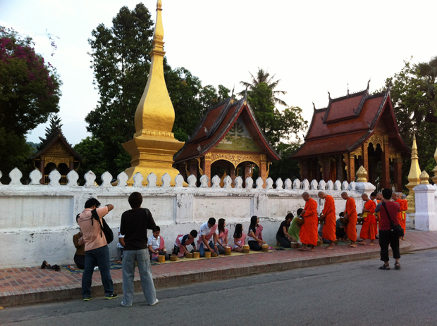 Tourists taking photos of morning alms